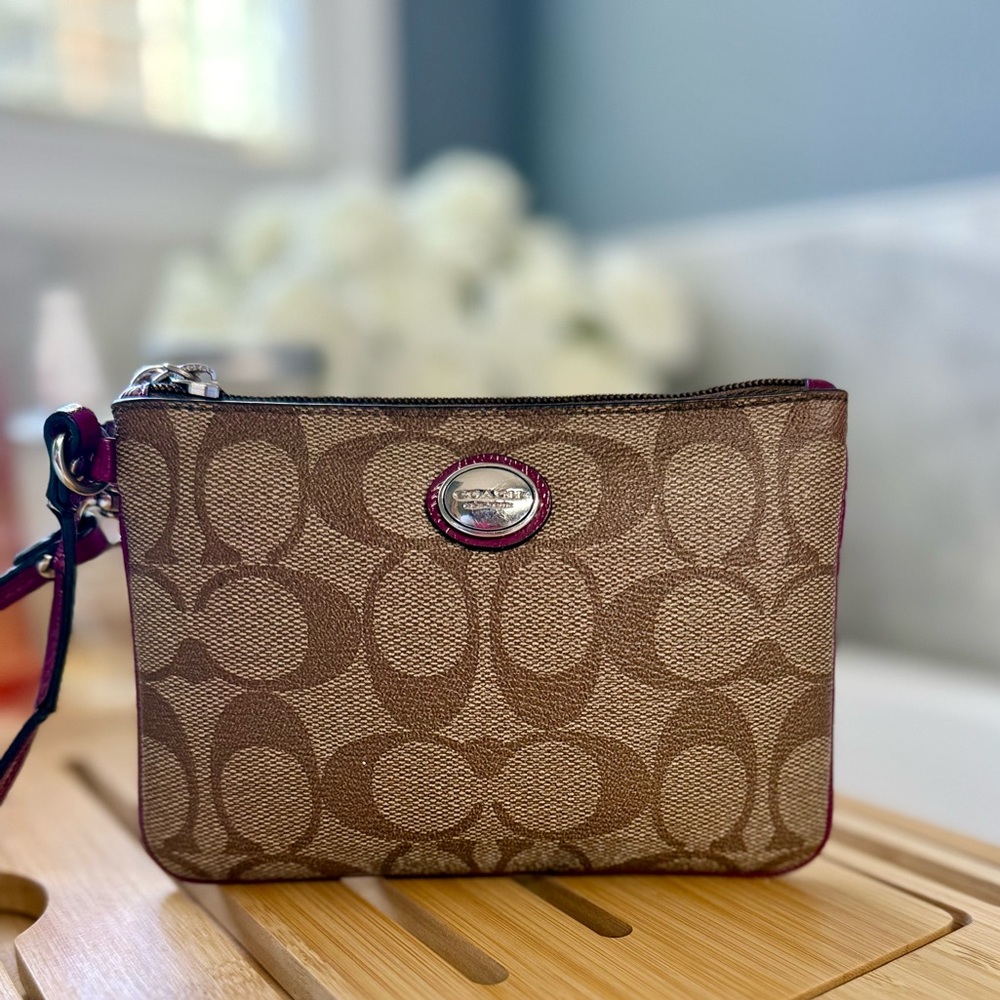 Coach Brown Signature Canvas Wristlet with Purple trim.